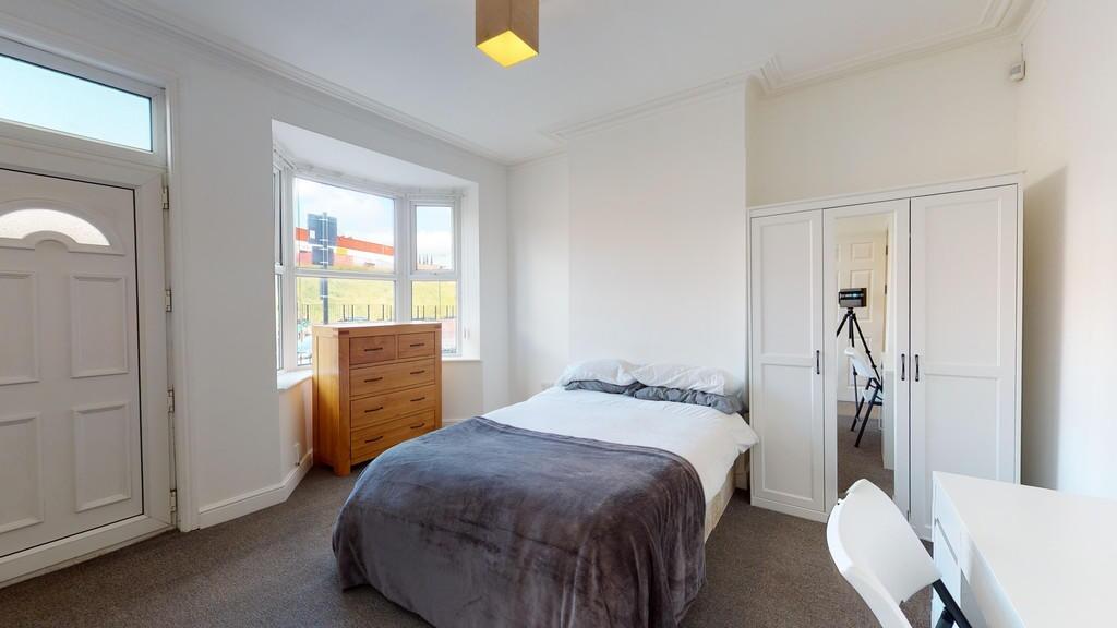 Bright and tidy double bedroom featuring a comf...