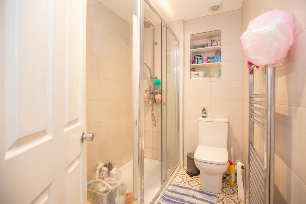 A well-maintained bathroom featuring a glass-en...