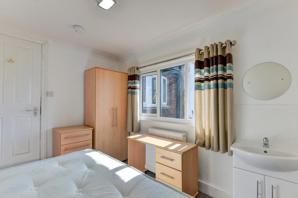 Bright and clean single toilet room featuring a...