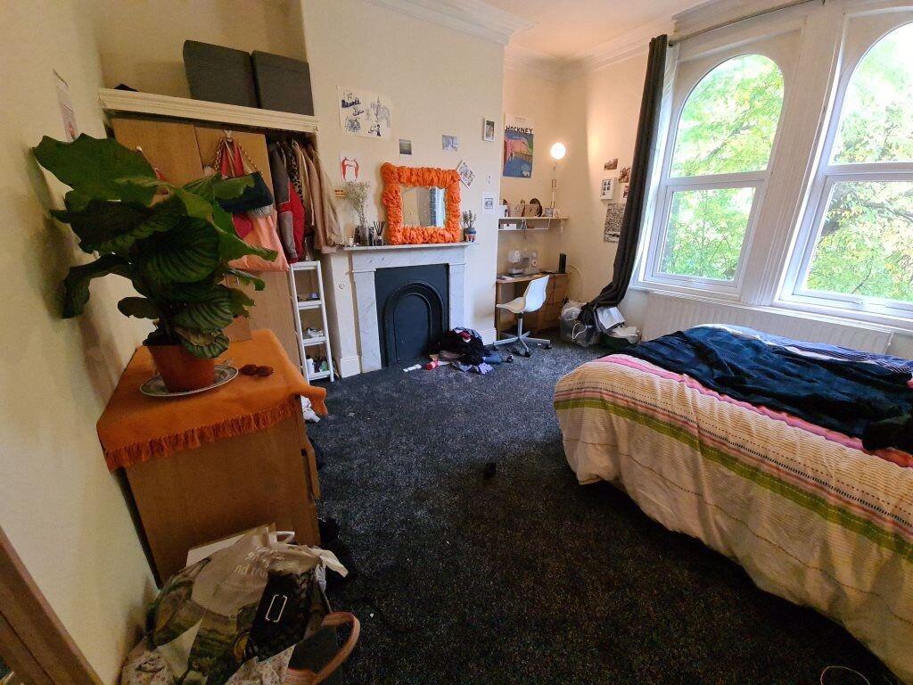 A cozy bedroom with a large window providing na...