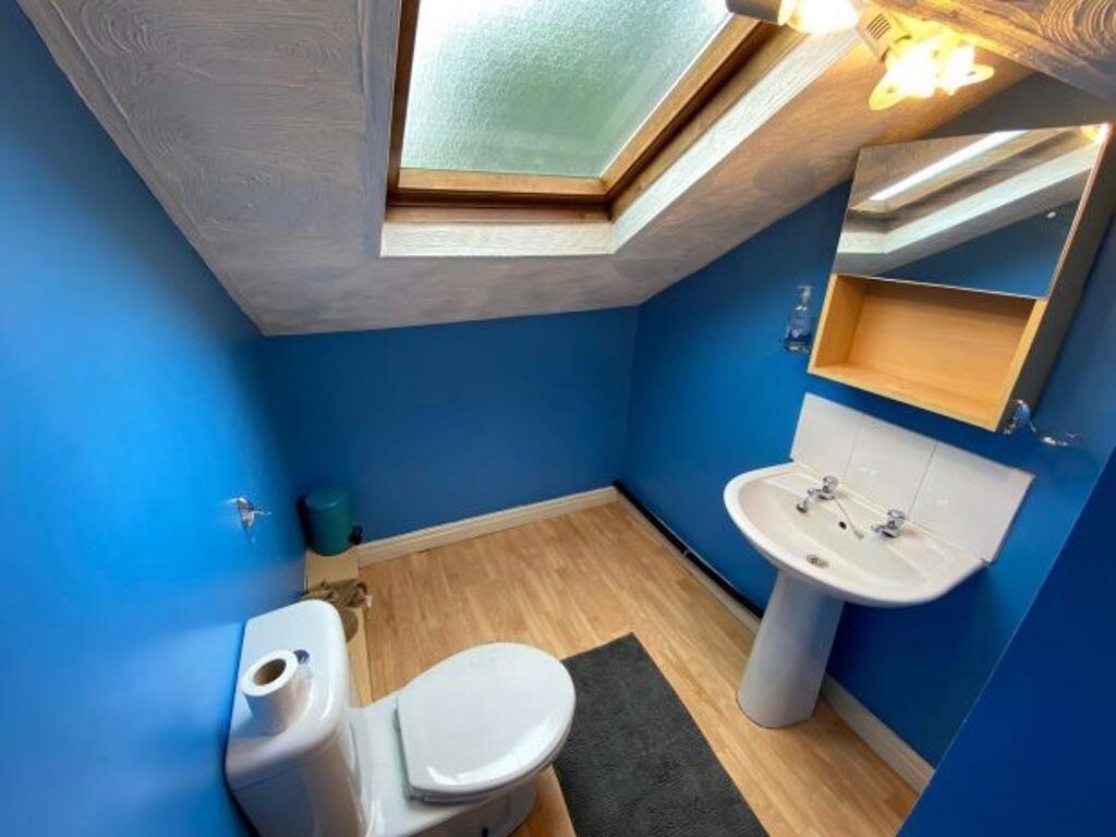 A clean and modern single toilet room featuring...
