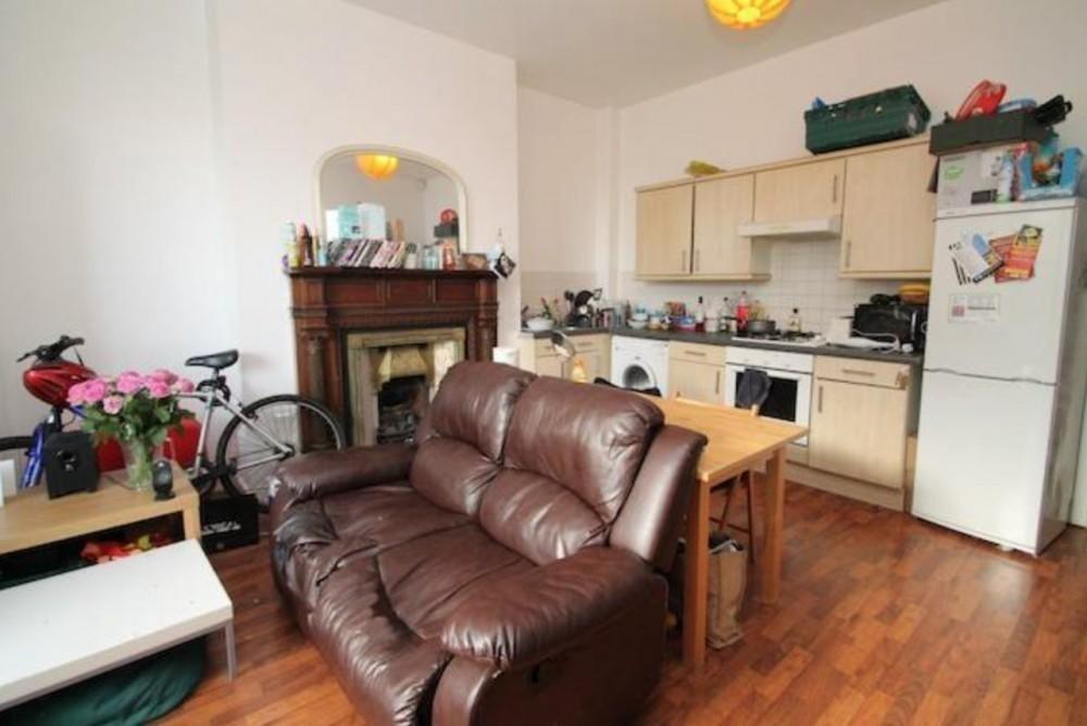 A cozy living space featuring a comfortable bro...