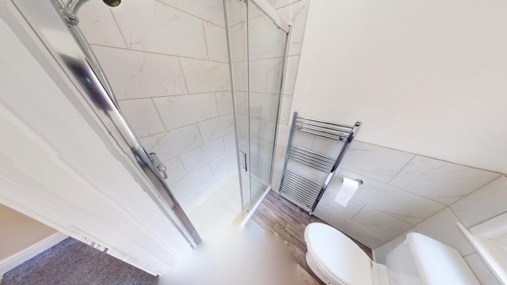 Bright and clean bathroom featuring modern fitt...