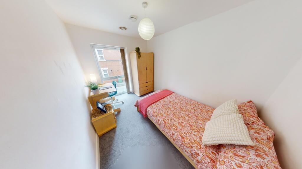 A bright and tidy single bedroom featuring a co...