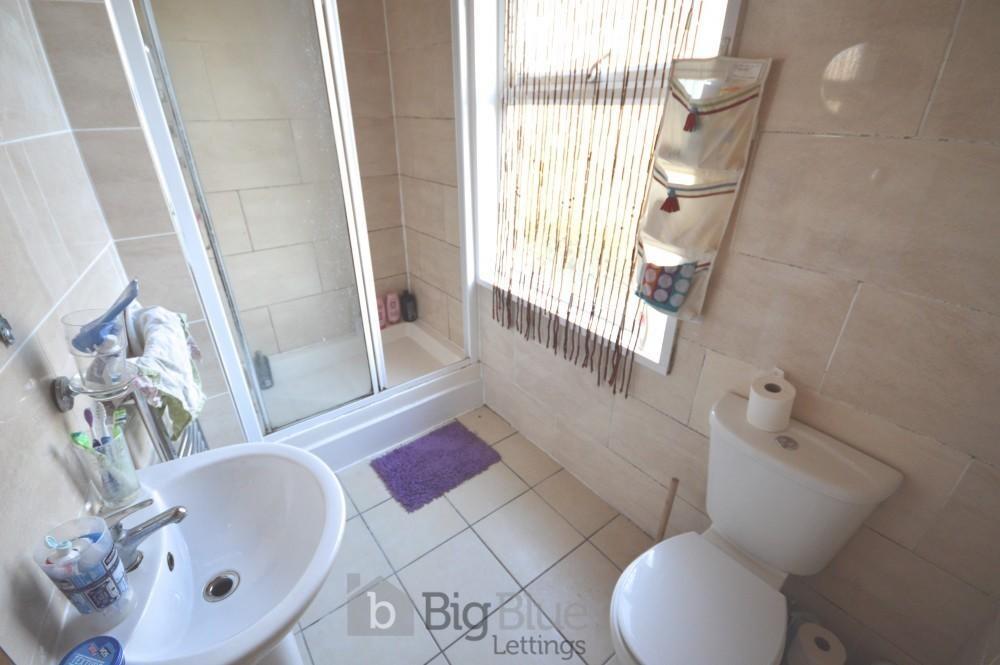 Bright and clean bathroom featuring a walk-in s...