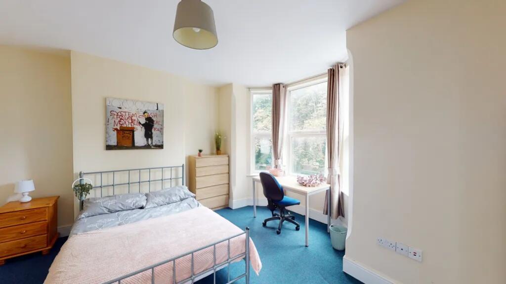 A bright and spacious double bedroom featuring ...