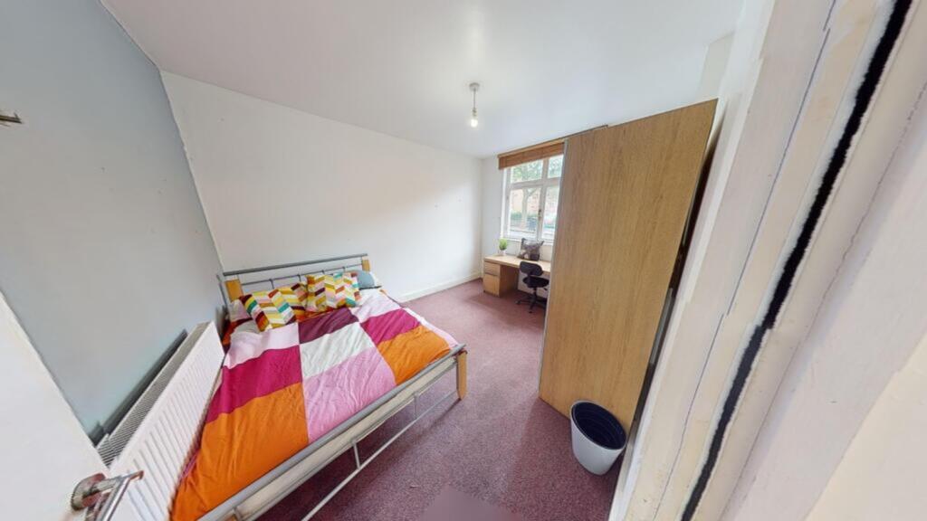 A bright and inviting double bedroom featuring ...