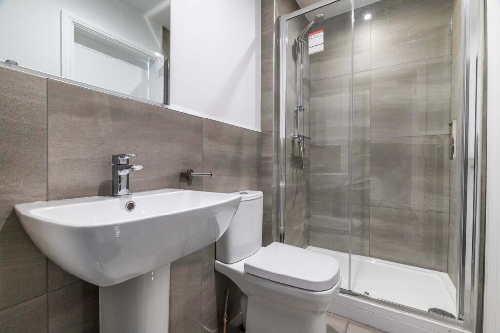 A modern, clean bathroom featuring a spacious s...