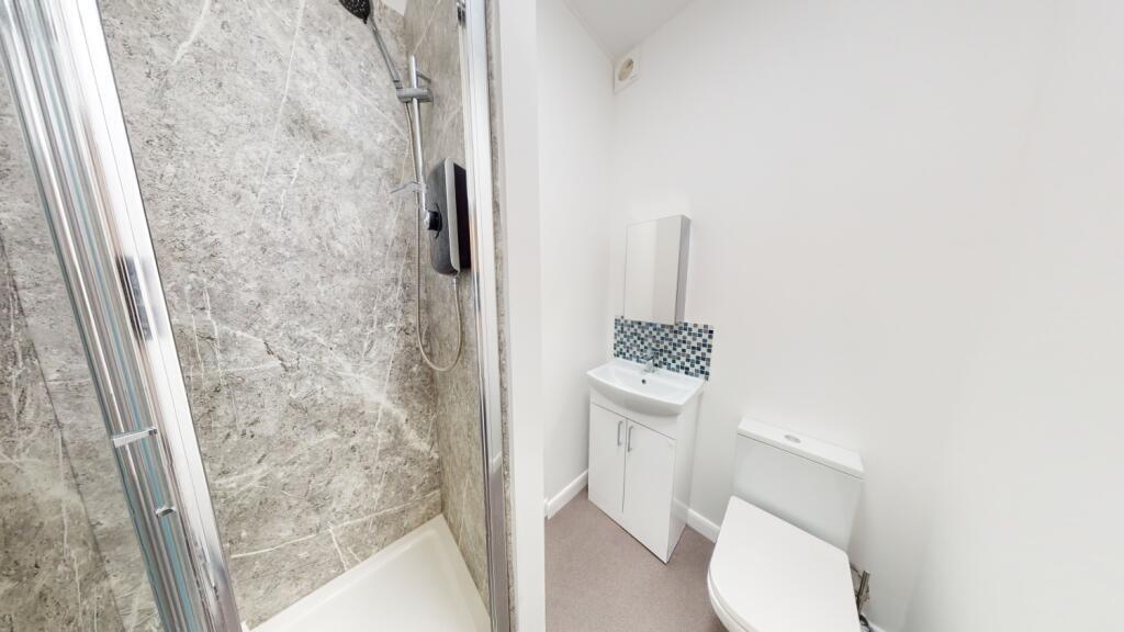 Bright and modern bathroom featuring a spacious...