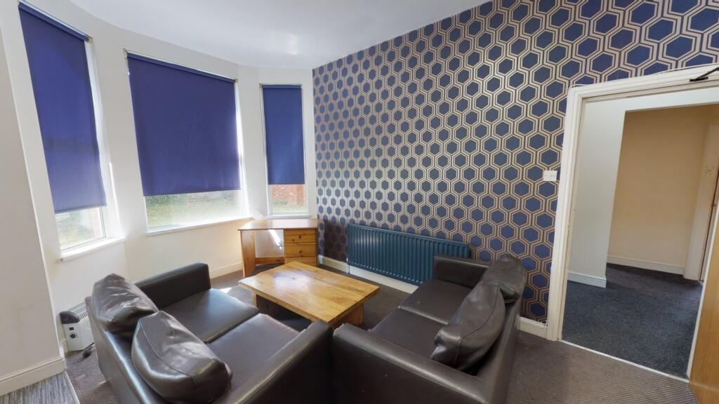 A cozy communal lounge featuring a set of dark ...