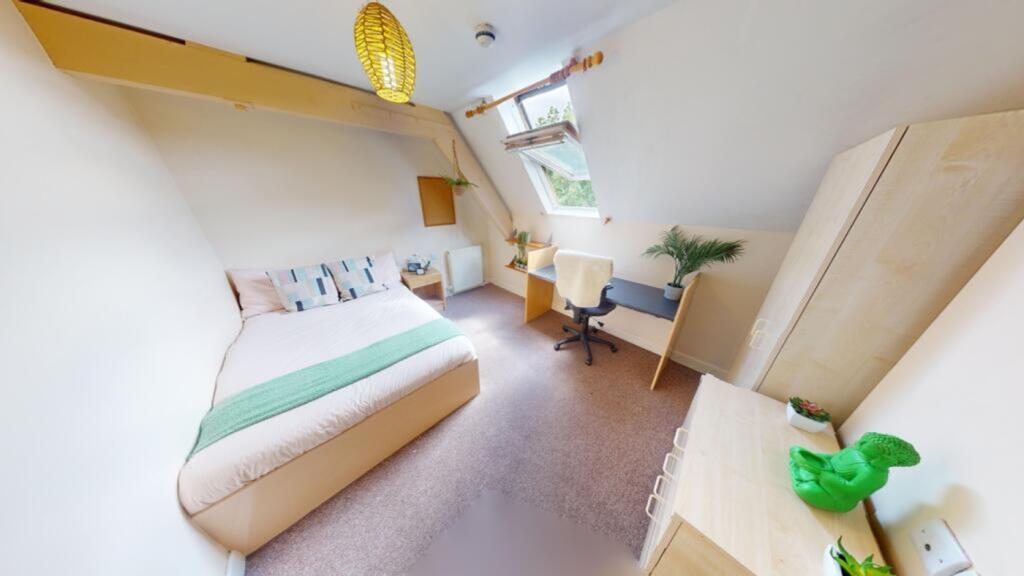 A spacious and bright double bedroom with moder...