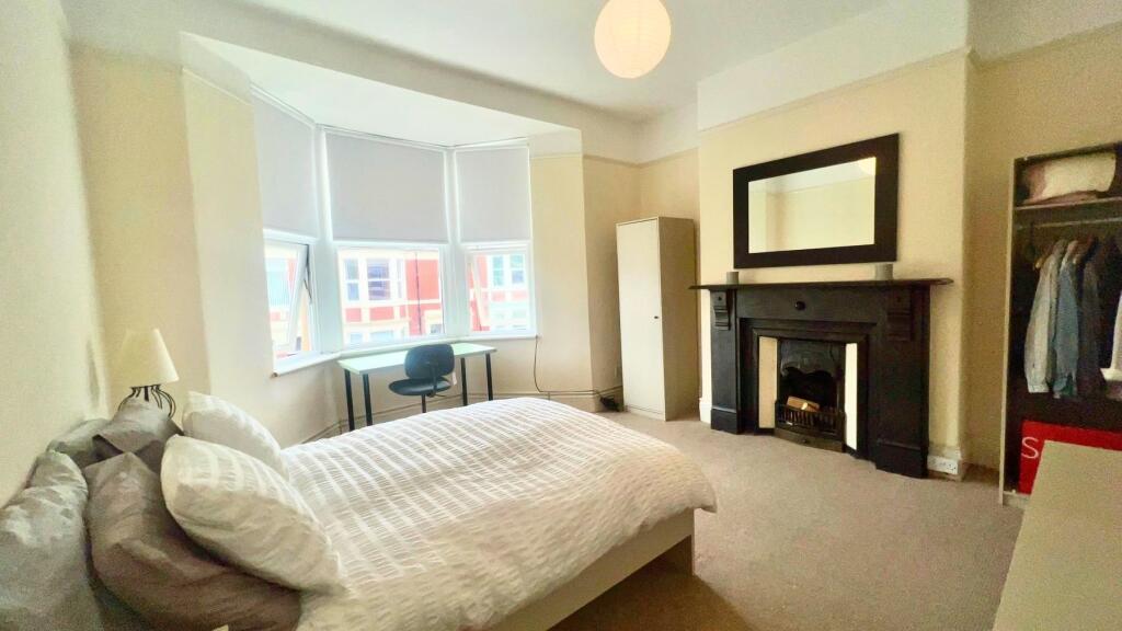 A bright and spacious master bedroom featuring ...