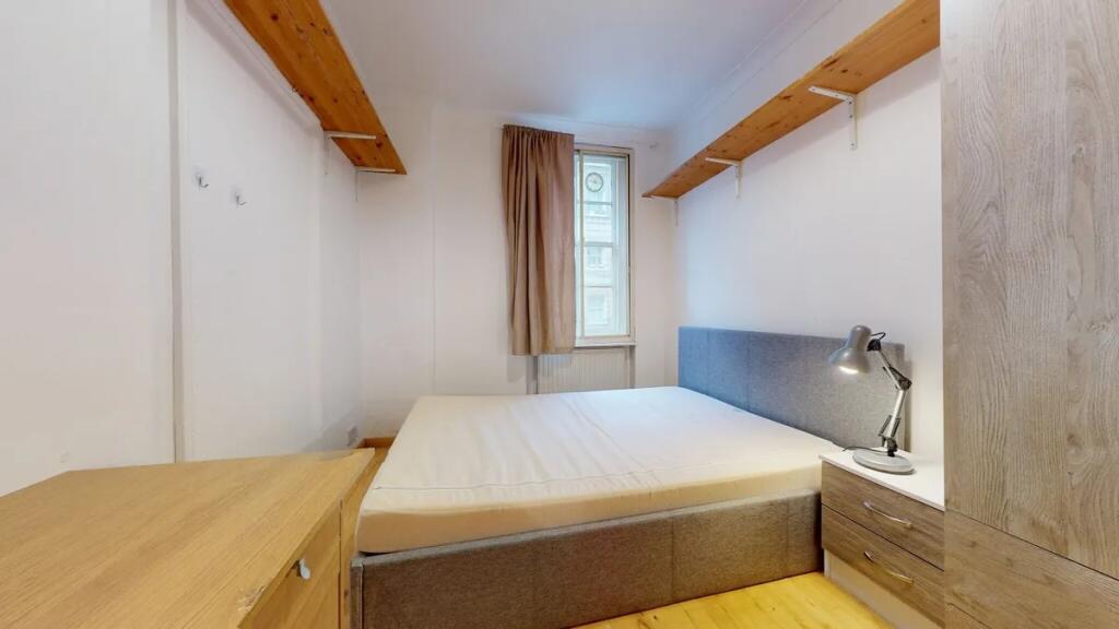 Bright and neatly arranged double bedroom featu...