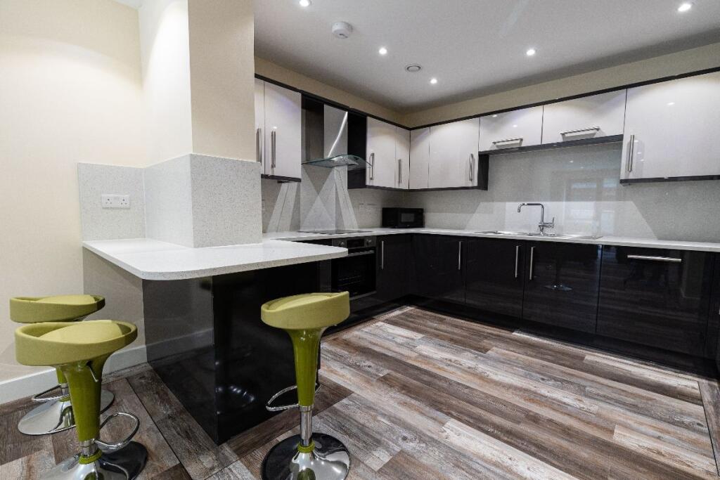 Modern kitchen with sleek black and white cabin...