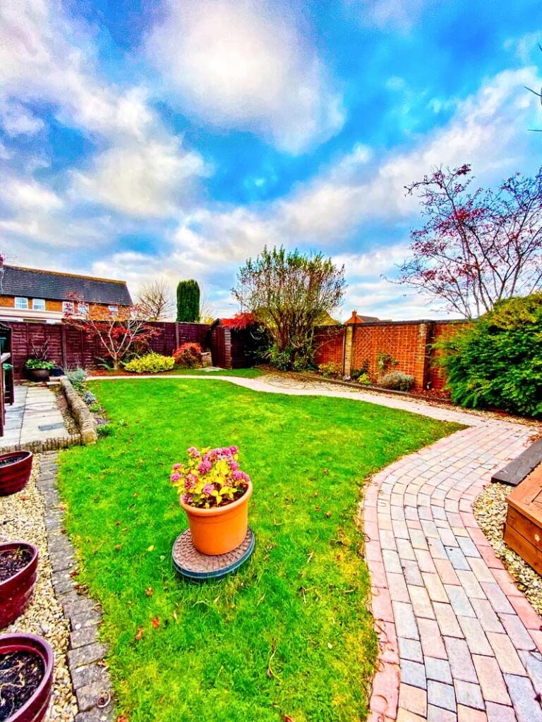 A beautifully landscaped garden featuring a vib...