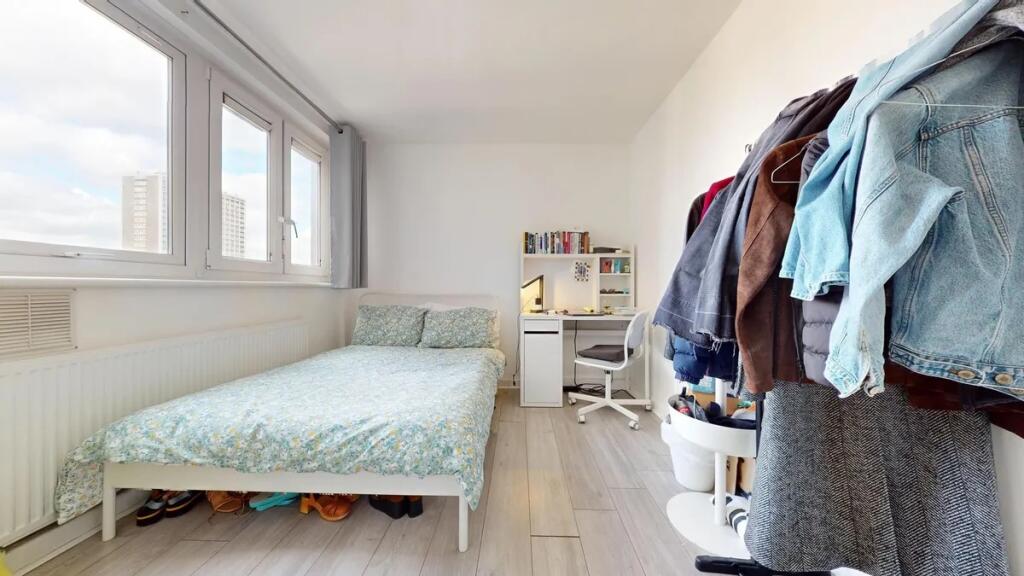 A bright and tidy single bedroom featuring a co...