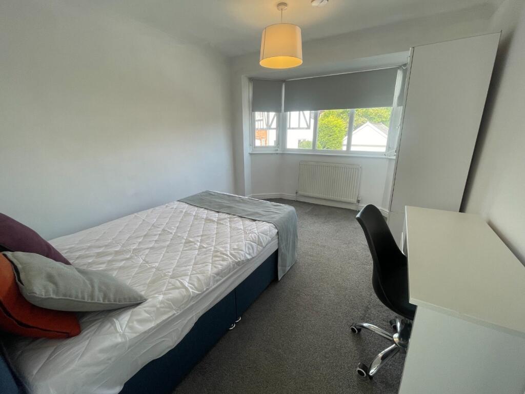 A bright and inviting double bedroom featuring ...