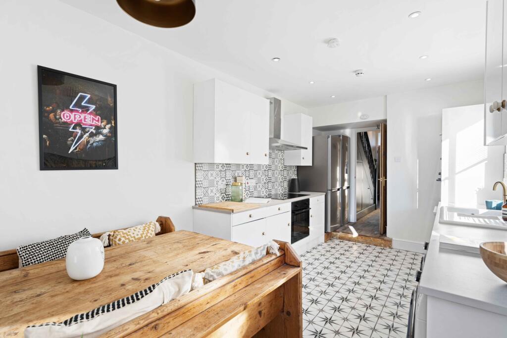 A bright and modern kitchen featuring stylish d...