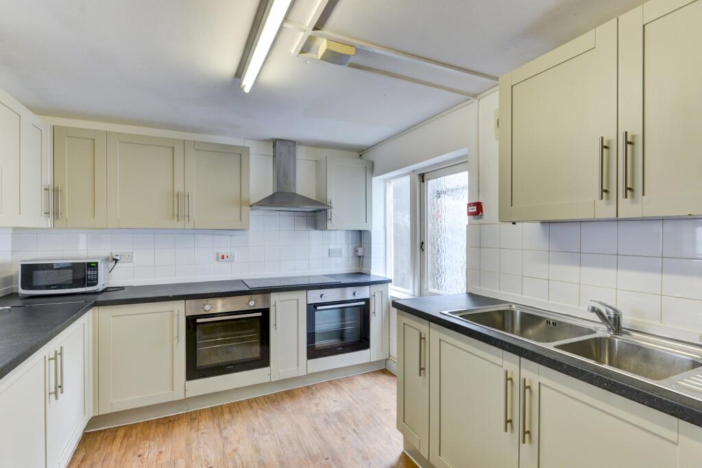 Bright and clean kitchen featuring modern appli...