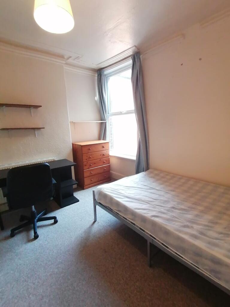 A bright and spacious double bedroom with a com...