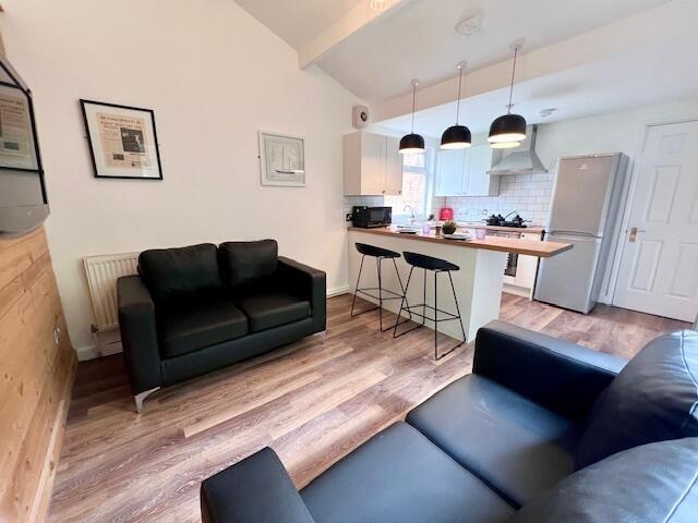 Bright and modern living room featuring comfort...