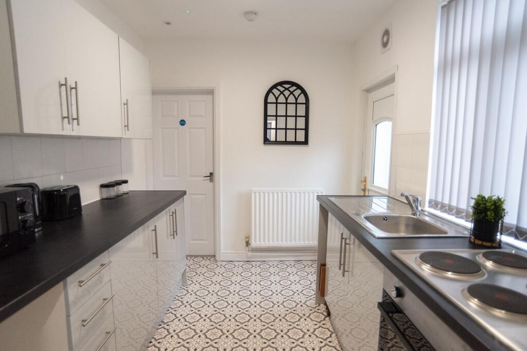 Bright and modern kitchen featuring sleek black...