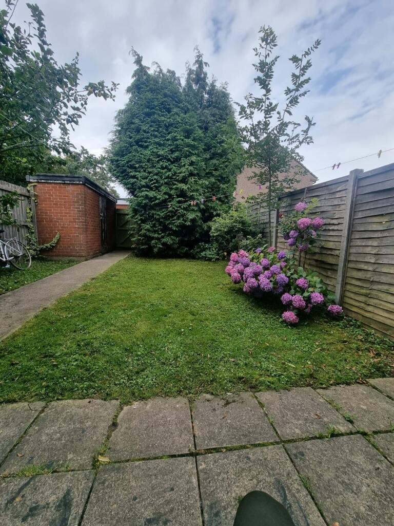 A serene garden space featuring a neatly mainta...