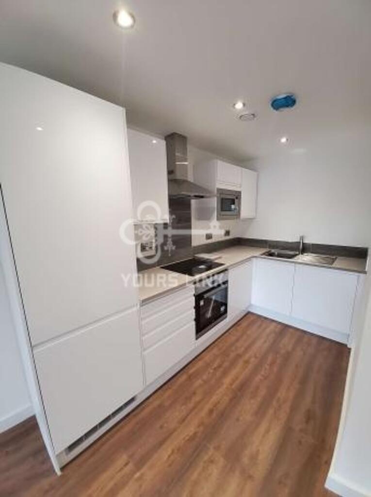A spacious and well-lit kitchen featuring moder...
