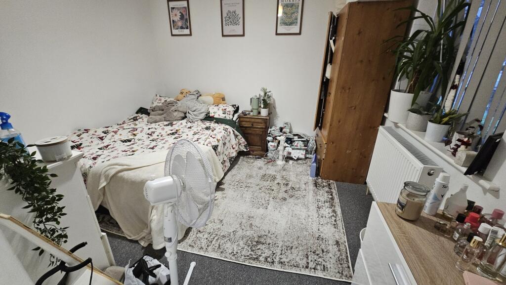 A cozy and well-decorated double bedroom featur...