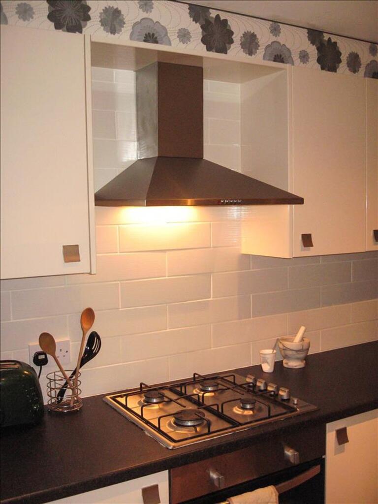 A modern kitchen featuring a sleek design with ...