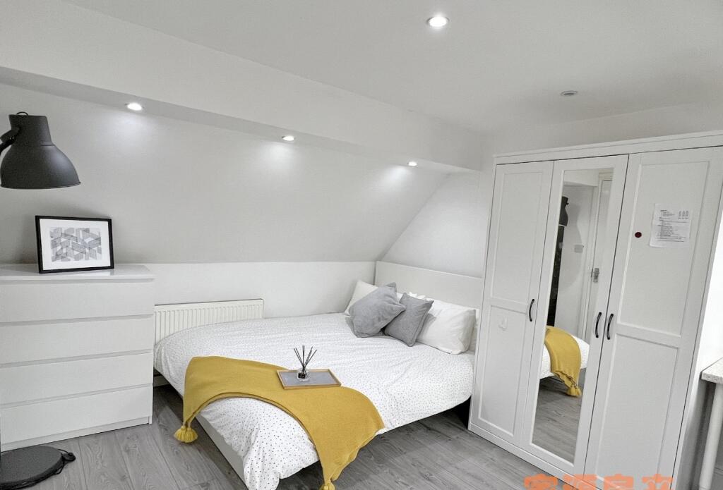 Bright and modern double bedroom featuring a co...