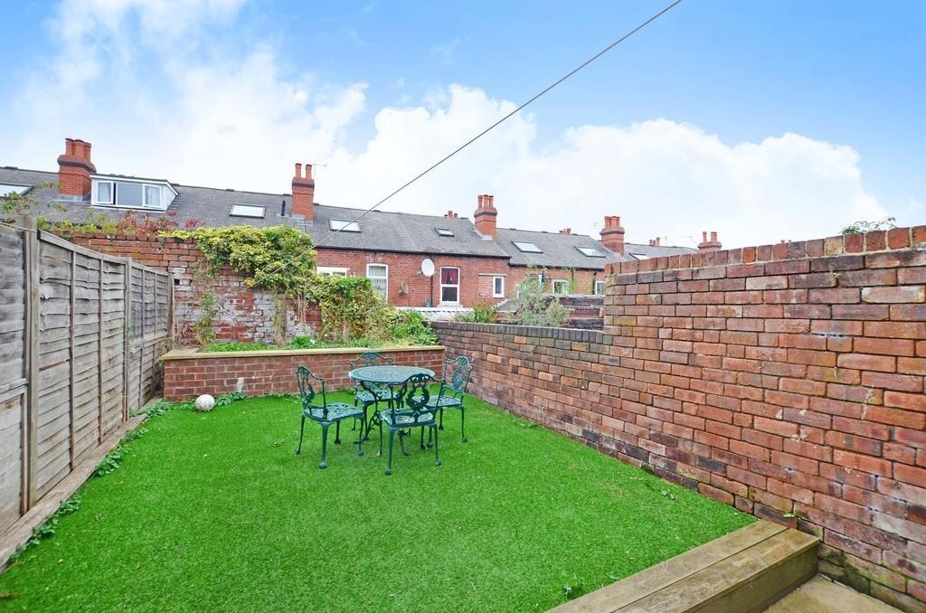 A well-maintained private garden featuring a gr...