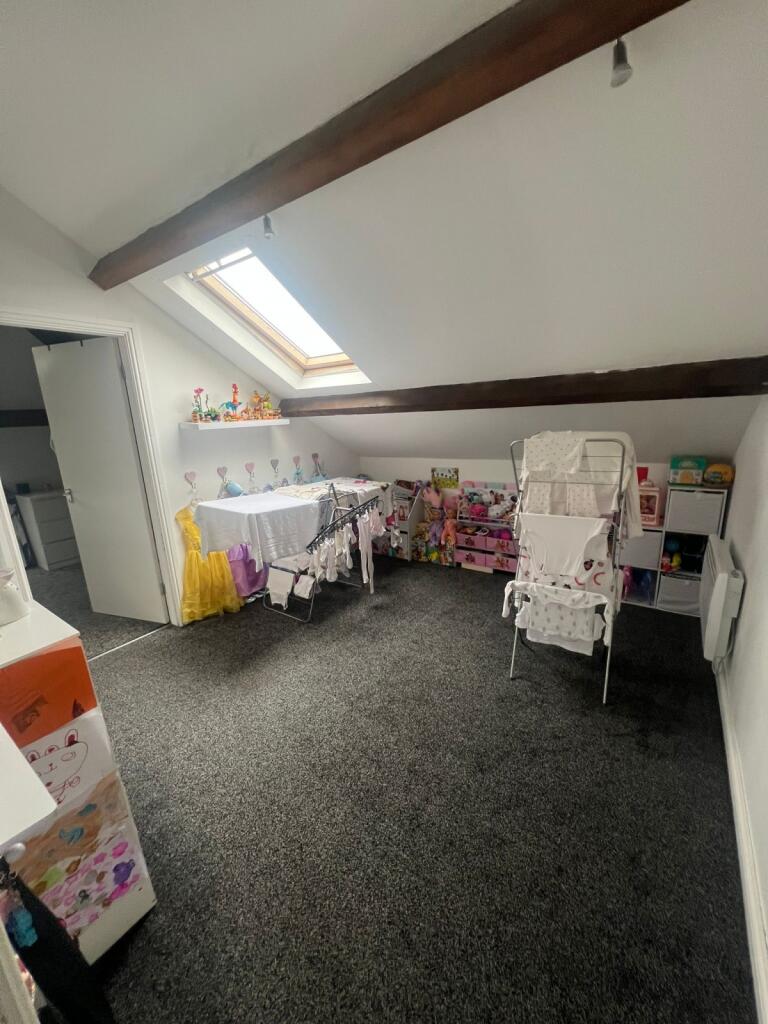 Bright and cozy living area with a large skylig...