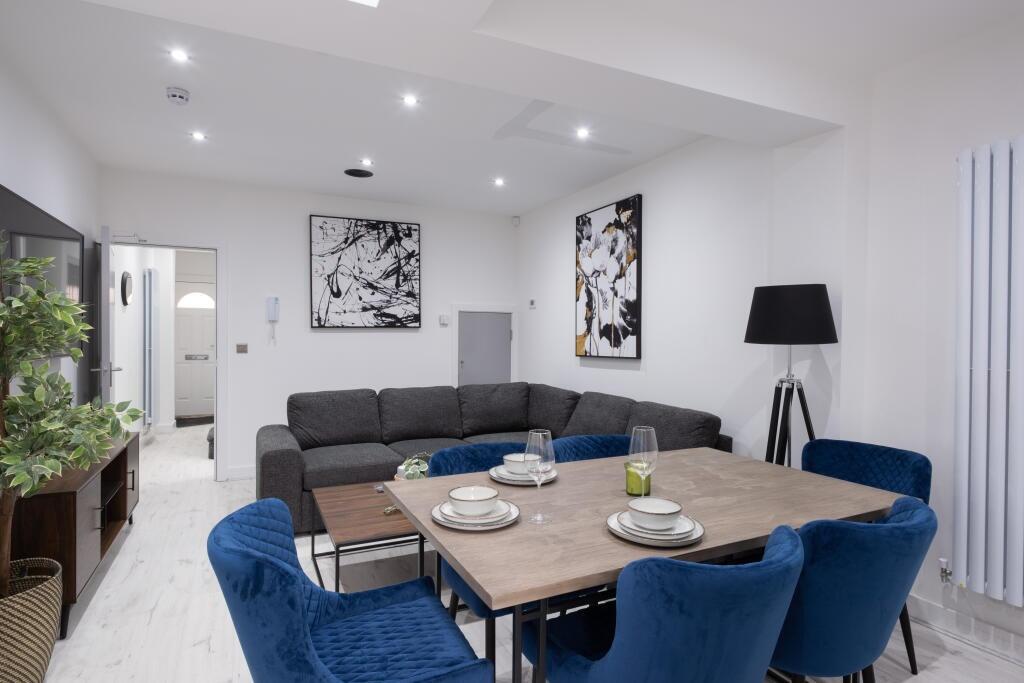 Spacious and modern living room featuring a coz...