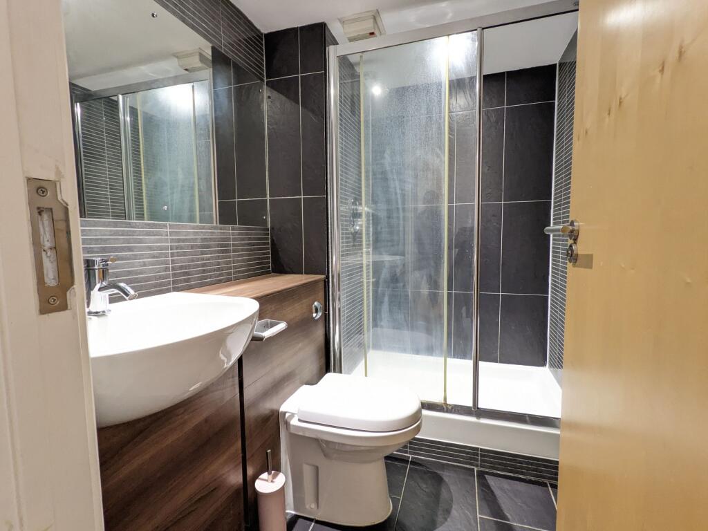 Contemporary bathroom with a walk-in shower, mo...