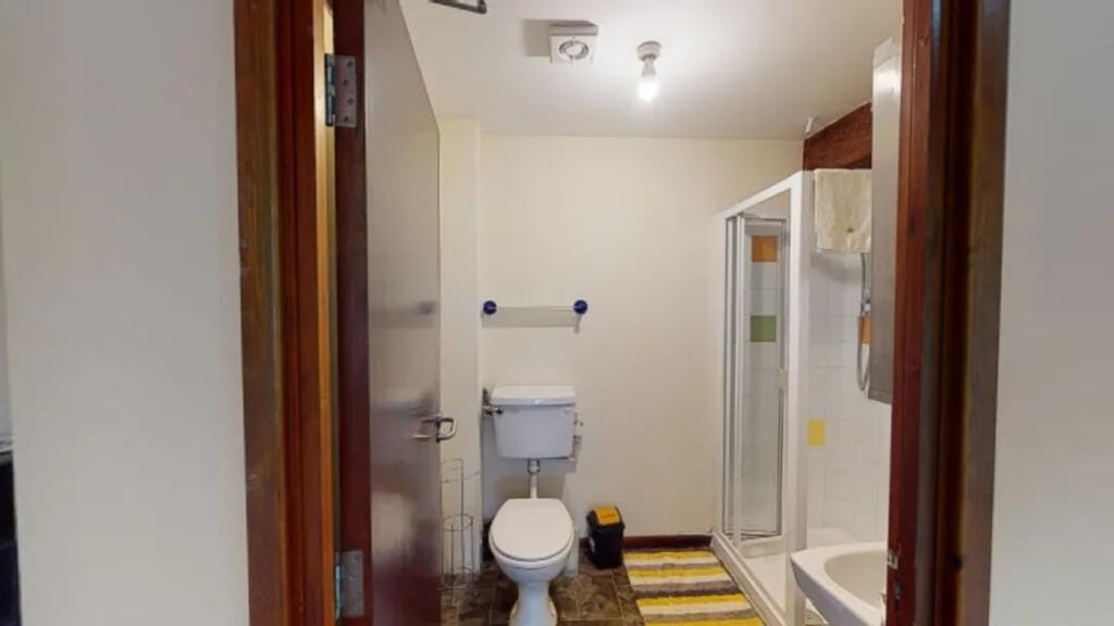 A tidy and bright bathroom featuring a shower a...