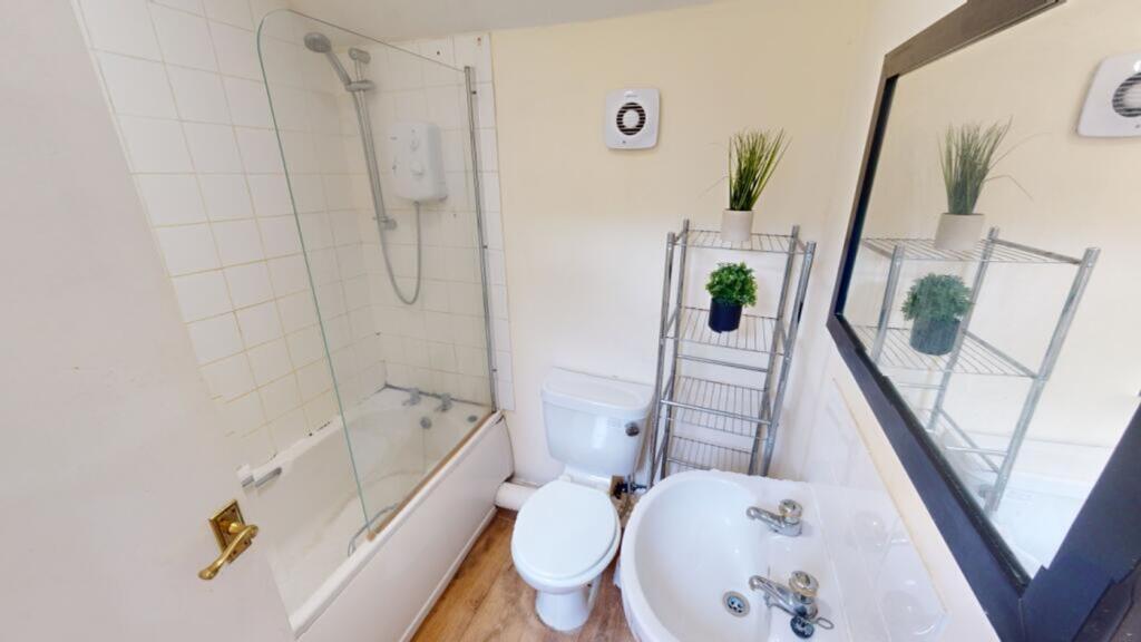 A bright and tidy bathroom featuring a modern s...
