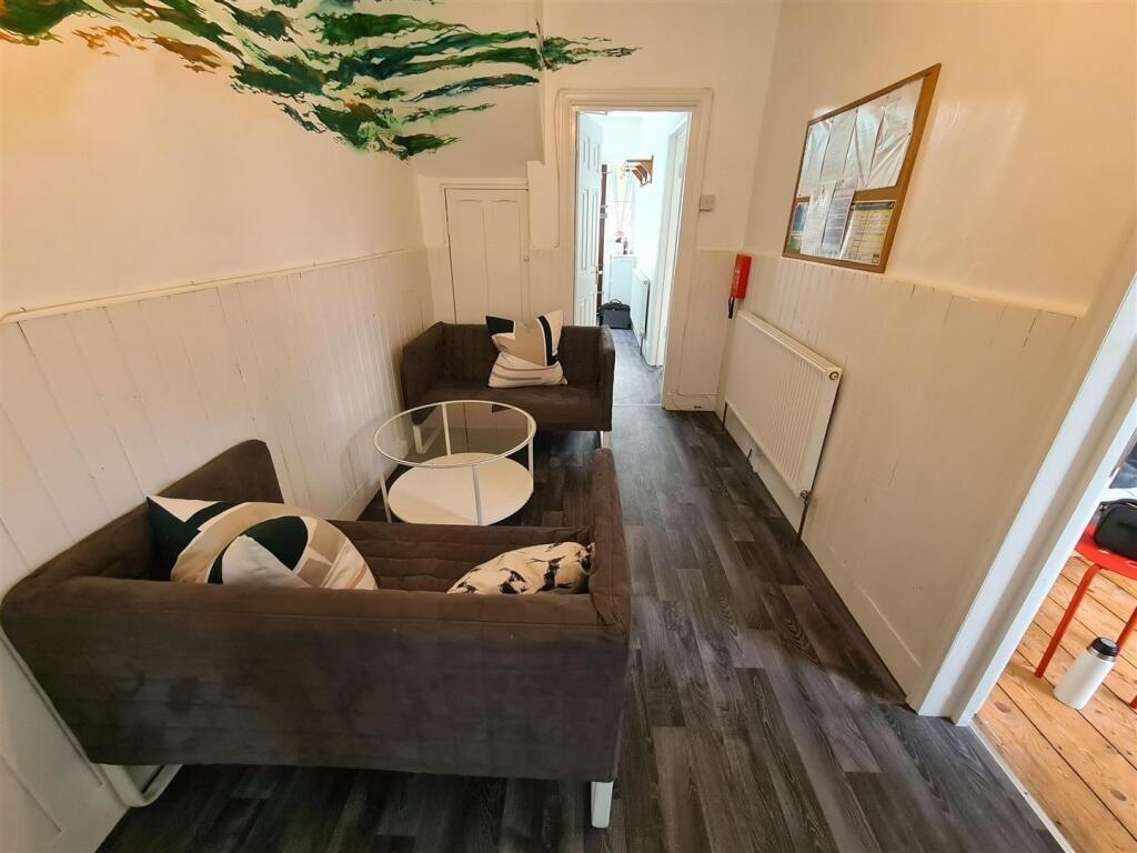 A cozy communal lounge featuring comfortable se...