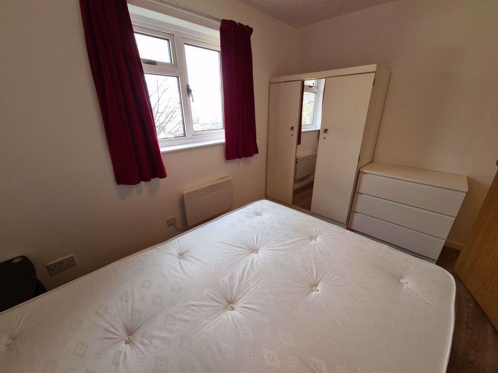 A neat and cozy double bedroom featuring a comf...