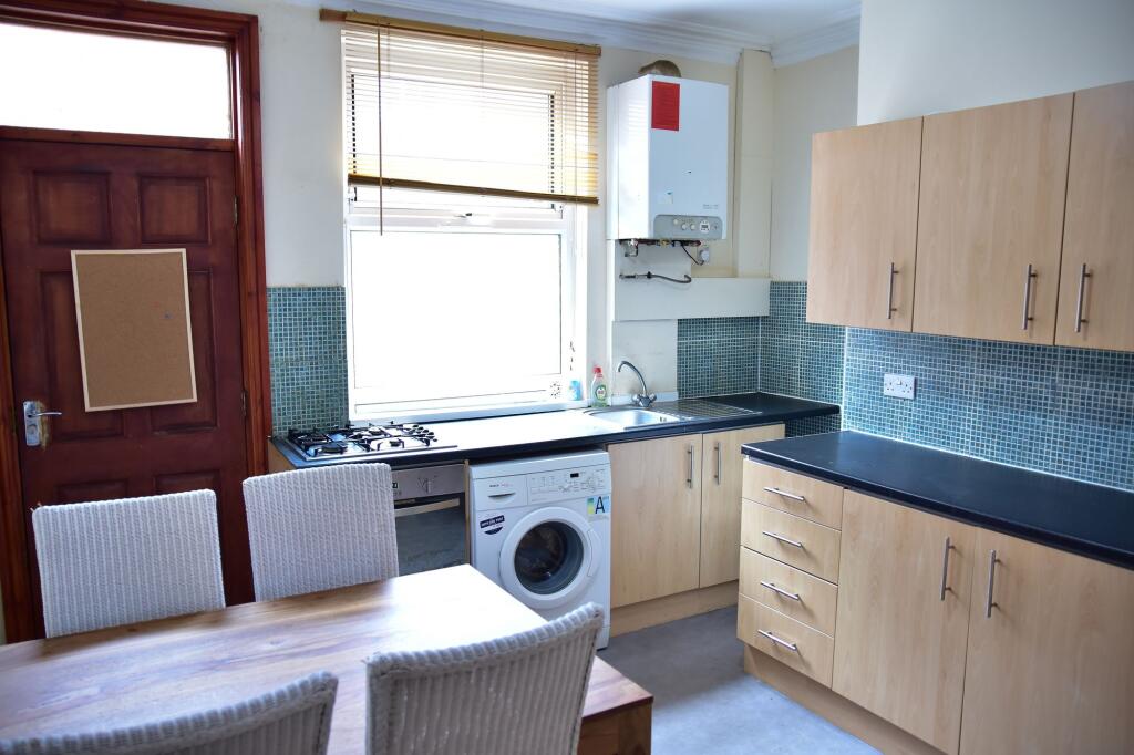 Bright and tidy kitchen area featuring modern c...