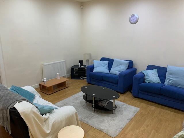 A cozy and well-maintained living room featurin...