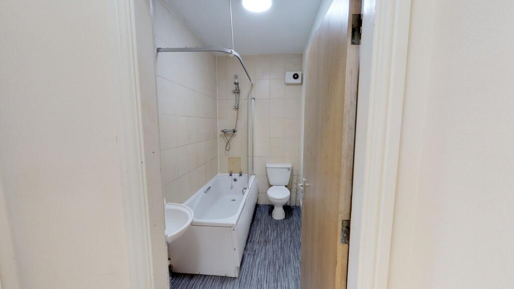 A neat and functional bathroom featuring a bath...