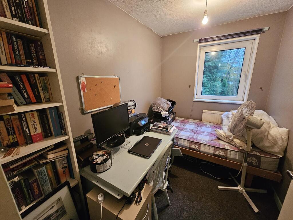 A small bathroom with a toilet, a sink, and som...