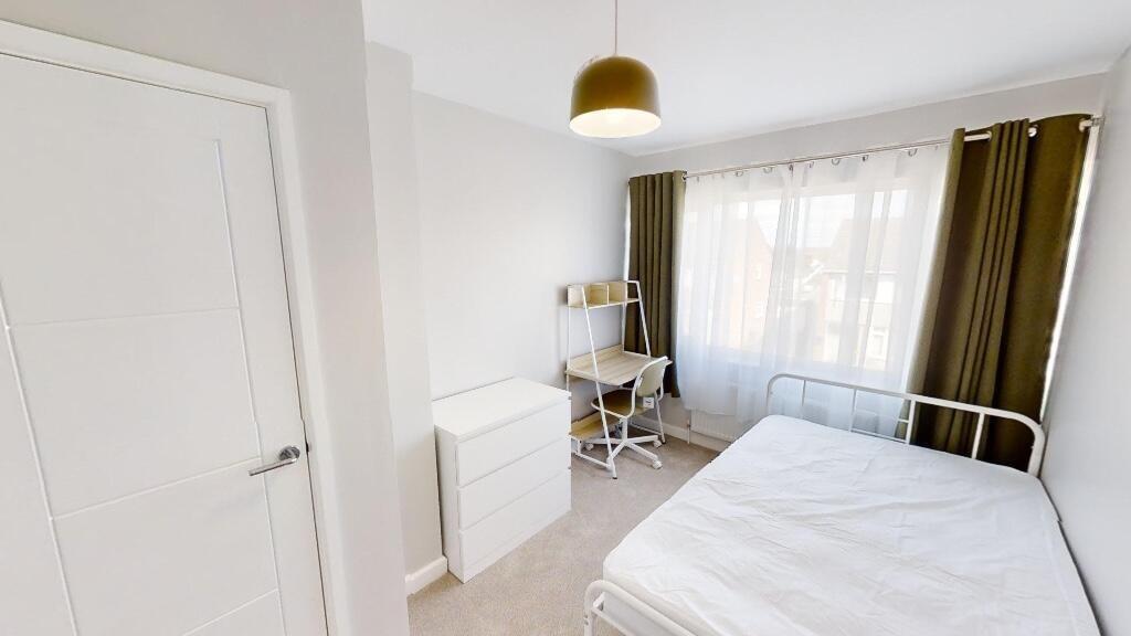 Bright and tidy double bedroom featuring a comf...