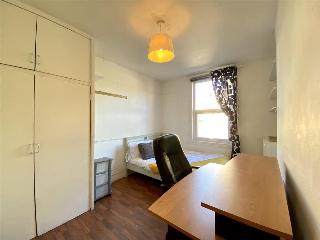 A neat and functional single bedroom featuring ...