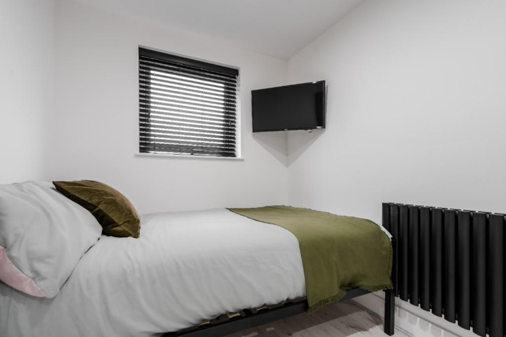 A modern and tidy double bedroom featuring a st...