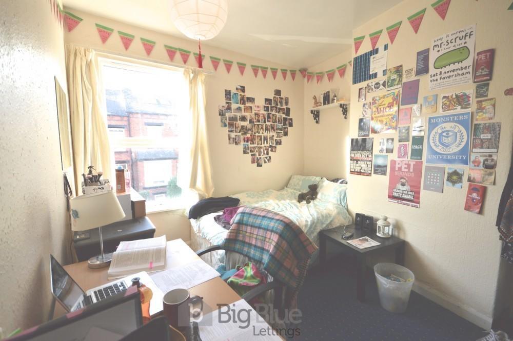 Cozy single bedroom featuring a comfortable bed...