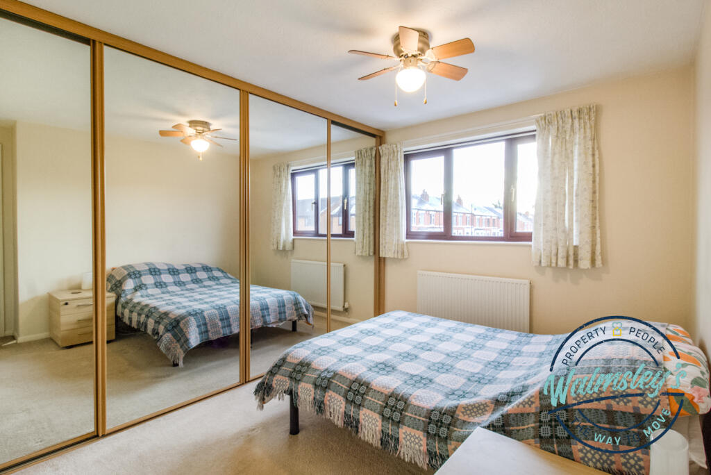 Main bedroom to frontage with fitted wardrobes
