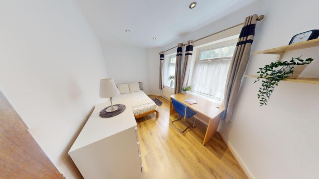 A bright and inviting double bedroom featuring ...