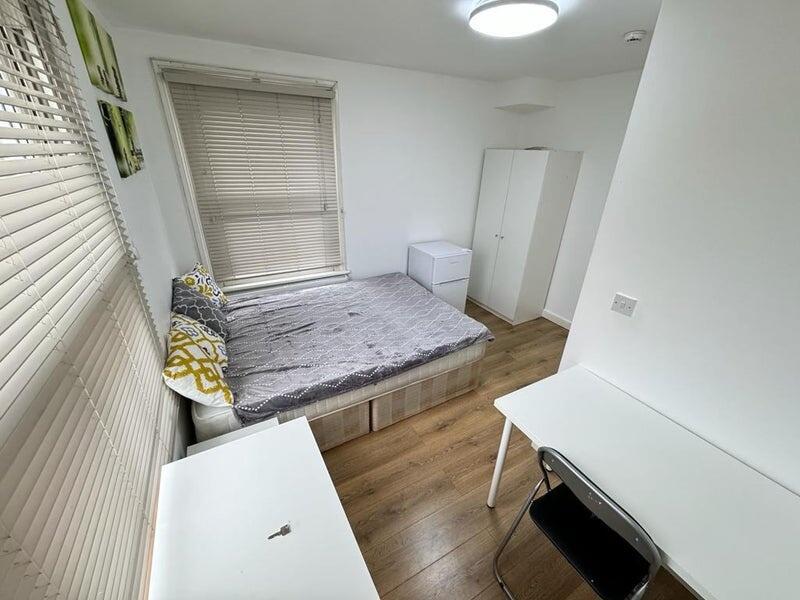 Bright and tidy double bedroom featuring a comf...